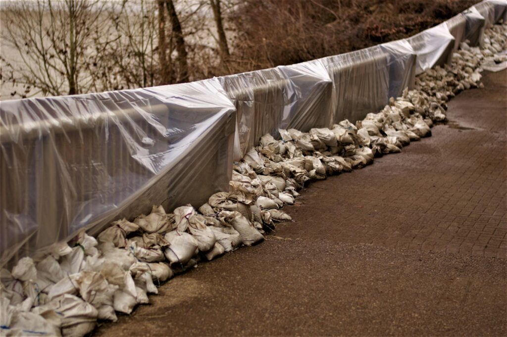 stack of sacks near the railings covered with plastics